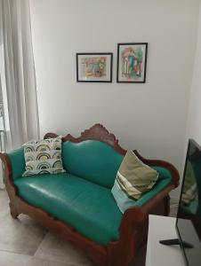 a green couch with pillows in a living room at Ca 'Romanel in Garda