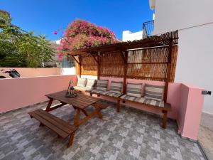 a bench and a table on a patio at Aiantas in Ermoupoli +53 photos