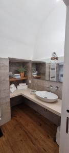 a bathroom with a large white sink in it at Carmela's guest house in Castellana Grotte +17 photos