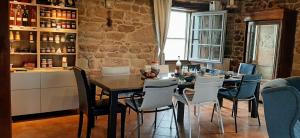 a dining room with a table and chairs at La Méridienne des Collines in La Motte-de-Galaure