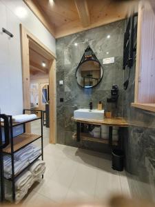 a bathroom with a sink and a mirror at Osada Bajka in Murzasichle
