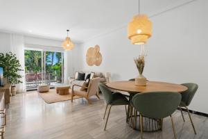 a living room with a table and chairs at Medina Garden 201 in Marbella +29 photos
