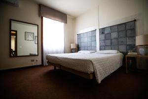 A bed or beds in a room at Hotel Rendez Vous