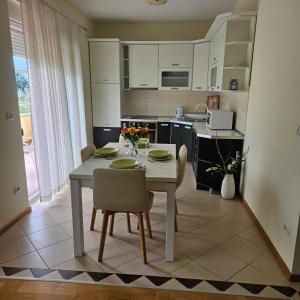 a kitchen and dining room with a table and chairs at Judita Apartments & Rooms in Međugorje