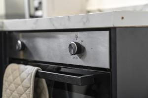 a close up of an oven in a kitchen at 1-Bed Home in Lanarkshire with Free Parking - Long Stays Available in Newarthill