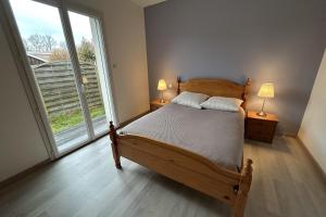 a bedroom with a bed and a large window at Beautiful 2-bedroom family home in Lanton