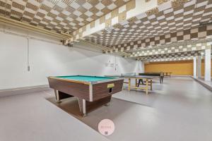 a room with two ping pong tables in it at Osean by BLOSS luxe appartement met frontaal zeezicht, binnenzwembad en parking in Middelkerke