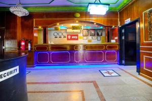 a bar with purple seats in a room at OYO 124 Al Salam Palace Hotel in Manama