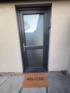a welcome sign in front of a door at The Loft in Eynsham