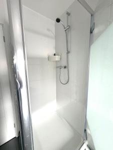 a shower with a glass door in a bathroom at The Loft in Eynsham +11 photos