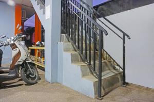 a staircase with a scooter parked next to a building at Hotel O Pondok Feby Makassar in Makassar