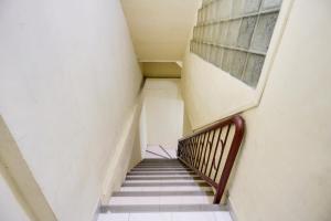 a staircase in an old building with a window at Hotel O Ringin Pitu 1 Syariah in Jodoh