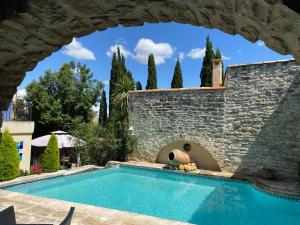 a teddy bear sitting next to a swimming pool at La Bergerie in Calvisson