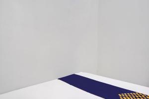 Postel nebo postele na pokoji v ubytování OYO 91403 Reva Residence Syariah