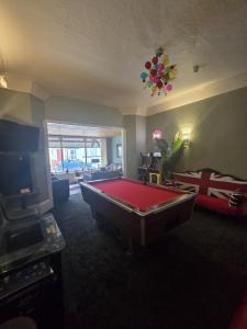 a room with a pool table in the middle of it at Maydene Hotel in Blackpool +37 photos