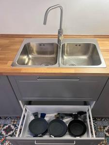 a kitchen sink with pots and pans in a drawer at Casa Magica Ogliastro in San Marco di Castellabate