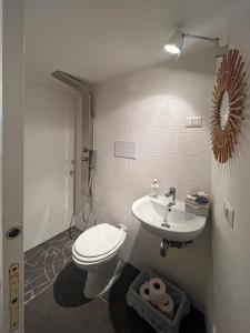 a bathroom with a white toilet and a sink at Casa Magica Ogliastro in San Marco di Castellabate +36 photos