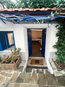 a doorway into a house with a blue door at Casa Magica Ogliastro in San Marco di Castellabate