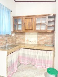 a kitchen with a sink and wooden cabinets at Villa Serenity in Negombo