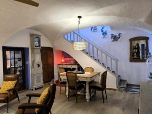 a dining room with a table and a staircase at Ca LA LIDIA GARRIGUELLA in Garriguella +17 photos
