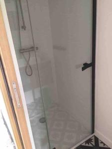 a glass shower door in a bathroom at chalet atypique proche Portbail Denneville in Saint-Lo-dʼOurville +13 photos