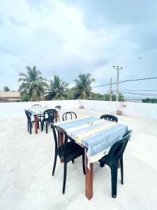 a group of tables and chairs on the beach at Villa Serenity in Negombo