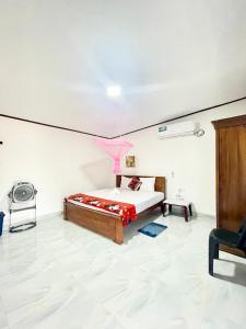 a bedroom with a bed in a white room at Villa Serenity in Negombo