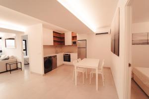 a kitchen and living room with a table and chairs at Palm Suites in Alicante