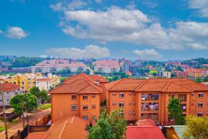 a view of a city with houses and buildings at Tranquil - 2 bedroom Spacious Condo with WIFI, 20 mins from KAMPALA CENTER in Kampala