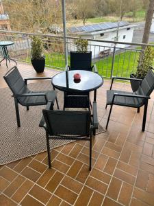 a patio with a table and chairs on a balcony at FeWo Rehborn in Rehborn