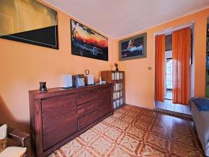 a living room with a wooden dresser in a room at Apartmán Úlehla 2 in Zlín