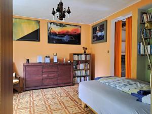 a bedroom with a bed and a dresser at Apartmán Úlehla 2 in Zlín
