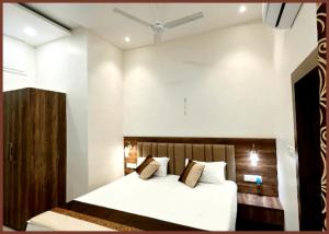 KashiA BUDUGET - MANAN GUEST HOUSE VARANASI, Near Kashi Vishwanath Temple - BEST HOTEL IN VARANASI的卧室里有一张床，床单和枕头都是白色的