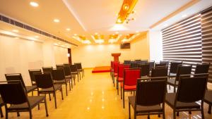 a room with rows of chairs and a podium at Dev Residency in Attingal