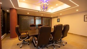 a conference room with a table and chairs at Dev Residency in Attingal