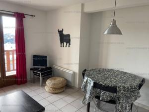 a dining room with a table and a cow on the wall at Appartement T3 avec garage, proche des pistes, 6 couchages - FR-1-295-205 in Les Angles