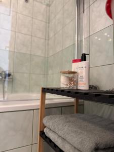 a bathroom with a shower and a table with towels at Buda's Crib apartment in Budapest +7 photos