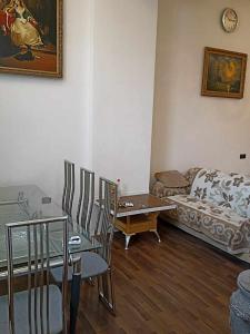a living room with a table and chairs and a couch at Vishapaqagh in Yerevan