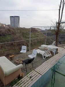 a patio with chairs and a table and a pool at Vishapaqagh in Yerevan