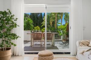 a living room with a door open to a patio at Medina Garden 201 in Marbella