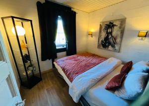 a small bedroom with a bed and a window at Le cocoon de Nanou in Anloy +33 photos