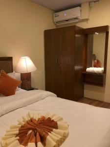 a hotel room with two beds with a flower on the bed at Zenith Apartments Thamel - Makalu 1BHK Apartment in Kathmandu