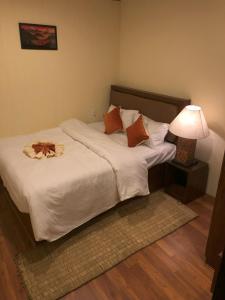 a bedroom with a large bed with a lamp on it at Zenith Apartments Thamel - Makalu 1BHK Apartment in Kathmandu