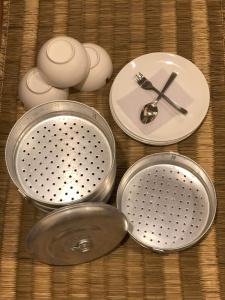 a group of utensils and a clock on a table at Zenith Apartments Thamel - Makalu 1BHK Apartment in Kathmandu