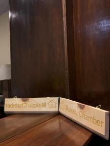 two boxes sitting on a table next to a wooden door at Zenith Apartments Thamel - Makalu 1BHK Apartment in Kathmandu