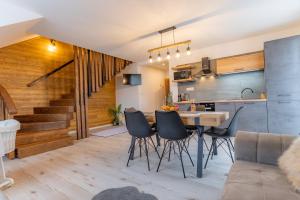 a kitchen and living room with a table and chairs at Miracle Seasons in Liptovský Mikuláš