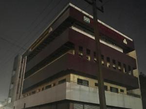 a building with a sign on the side of it at Townhouse Dharawada Taluku Formerly Shri Balaji Hotel in Mugad