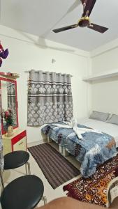 a bedroom with a bed and a ceiling fan at Chandrajyoti Villa 5 Ground floor Villa in Nagpur +15 photos