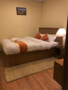 a bedroom with a bed with a dog laying on it at Zenith Apartments Thamel - Cho Oyu 1BHK Apartment in Kathmandu