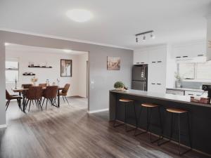 a kitchen and dining room with a table and chairs at Modern holiday home in Hobart - Stunning Mountain & Water views in Rosetta +67 photos